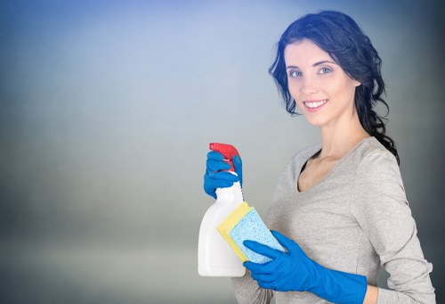 Cleaner wearing PPE while treating a carpeted area safely